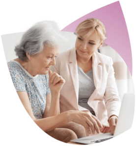 A Support Worker helps an NDIS Participant use an electronic device before writing NDIS Case Notes.